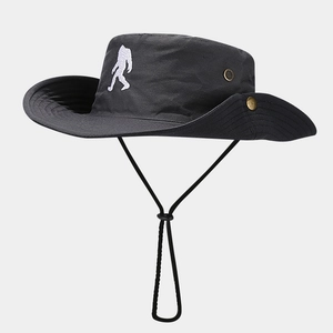 Detail of outdoor sun hat featuring white sasquatch embroidery and adjustable wind cord