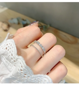 Close-up of double-layer silver ring with sparkling zircon pavé on a woman's hand
