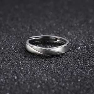 Modern twisted silver open ring with contrasting polished and brushed metal finishes