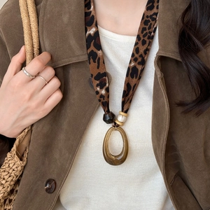 Leopard print fabric necklace with brown resin oval pendant and vintage wooden beads