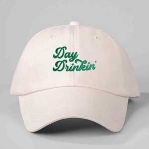 Beige cotton baseball cap featuring green Day Drinkin' embroidery in a classic curved brim style