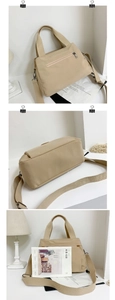 Detail view of a beige nylon tote bag with adjustable strap and multiple compartments