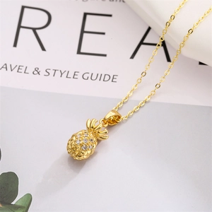 Macro view of gold plated pineapple pendant necklace with sparkling cubic zirconia