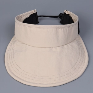 Detailed top view of a beige sports visor featuring reinforced stitching and adjustable cord