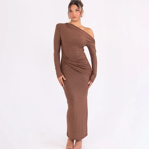 Detail of glitter brown fabric with waist twist knot on an asymmetric maxi dress