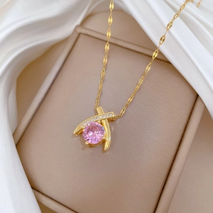 Detail of pink zircon pendant on gold chain with micro-inlaid white diamonds