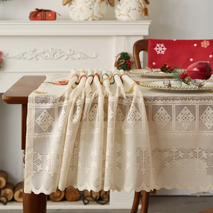 Close-up of festive Christmas lace table runner with snowflake cutout patterns