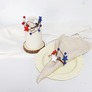 Detail of USA Independence Day napkin rings with red white blue stars and berry accents