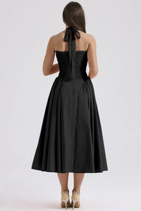Back view of a black halter neck backless midi dress showing tie-up details and elegant fit