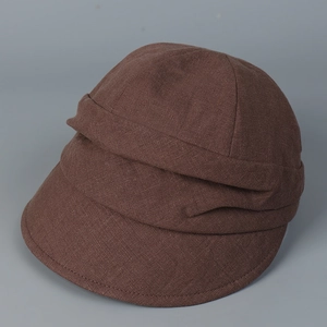 Detailed view of dark brown linen sun hat featuring a textured cross-weave and pleated design