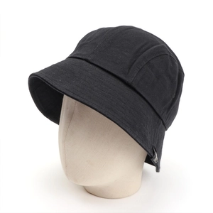 Close-up of black cotton bucket hat with a woven logo label and decorative stitching details