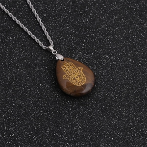 Hamsa Hand necklace with teardrop tiger eye stone pendant on a silver rope chain