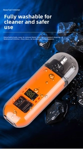 Waterproof orange nose hair trimmer with LCD battery display on blue water background