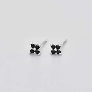 Macro shot of S925 sterling silver stamp on four-leaf flower stud earring with black stone