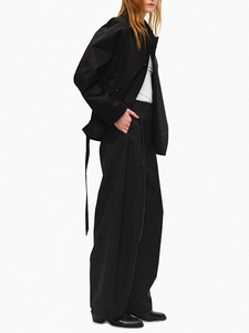 Short black double-breasted trench coat paired with high-waist wide-leg trousers