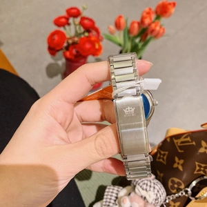 Detailed close-up of a silver stainless steel watch strap with a custom brand clasp
