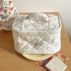 Quilted cherry polka dot cosmetic bag with rainbow Melody embroidery on handle