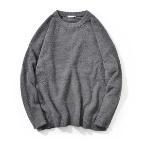 Close-up of dark grey crewneck knit sweater showing chenille texture and premium weaving