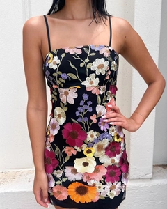 Detailaufnahme der filigranen, bunten Blumenstickerei auf einem schwarzen Netzkleid