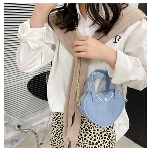 Light blue heart-shaped jelly handbag with glossy finish and metal chain shoulder strap