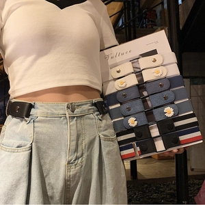 Close-up of elastic waist belt with daisy pattern and leather snap button closure