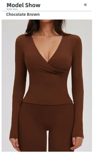 Detail of the chocolate brown V-neck yoga top showing elastic fabric and cross-wrap design