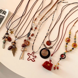 Bohemian vintage long necklaces with wood beads, feathers and star pendants for women