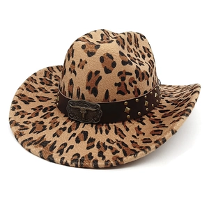 Detail of leopard print cowboy hat featuring a bronze bull head buckle and studs