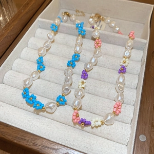 Floral seed bead and faux pearl necklace in blue and multicolor gold plated styles