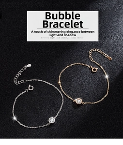 Macro detail of bubble bracelets in silver and rose gold finishes with lobster clasp