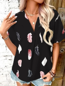 Detail of V-neck shirt featuring colorful feather prints and bohemian style pattern