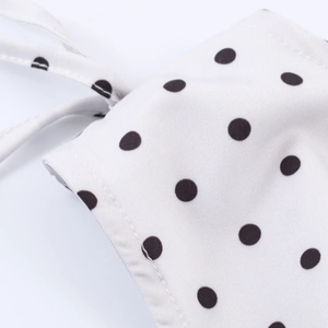 French vintage white sleeveless top with black polka dots and side tie waist detail