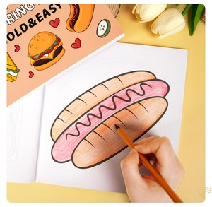 Macro view of a child coloring a cartoon hot dog page with an orange pencil in the coloring book