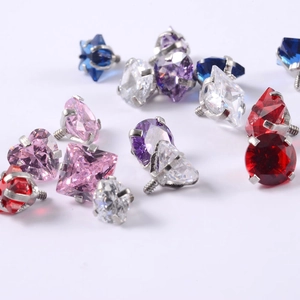 Macro view of heart and star zircon stud earring parts in various vibrant colors