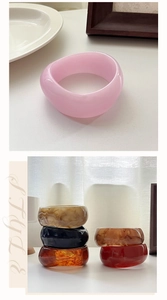 Macro shot of colorful chunky resin bangles with marbled texture in various stylish shades