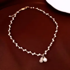Elegant pearl choker necklace featuring a zircon gourd pendant on a velvet background