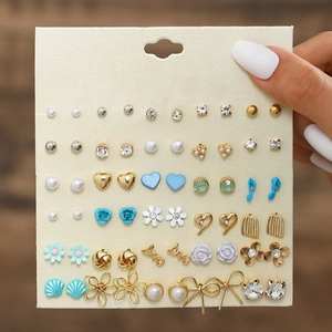 Detailed set of 20 pairs of fashion stud earrings including pearls and floral designs