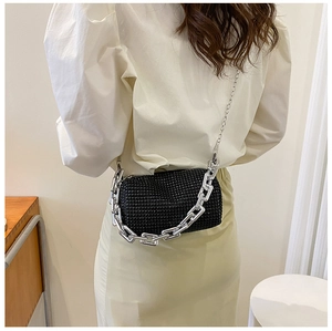 Detail of black rhinestone mini crossbody bag with stylish silver chunky chain and slim strap