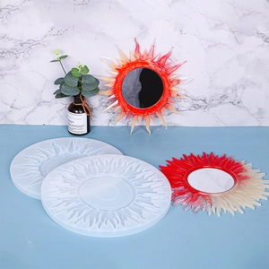 Detailed sun-shaped silicone mold with DIY resin sun mirrors on a blue surface