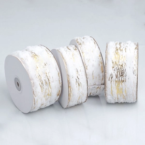 Close-up of white plush ribbons with gold foil patterns for Christmas DIY decorations
