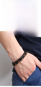 Detail view of woven PU leather and tiger eye stone bead layered bracelet set