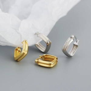 Close-up of elegant double-layered square hoop earrings in polished gold and silver finishes