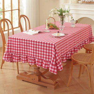 Red and white checkered rectangular tablecloth with elegant ruffled edges for dining tables