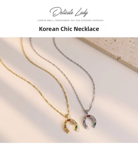 Macro detail of horseshoe pendant necklace with colorful zircon stones in gold and silver