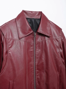 Detail of burgundy faux leather jacket with white contrast stitching and silver metal zipper