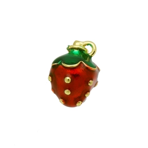 Close-up of a red enamel strawberry pendant with green leaves and gold seed details