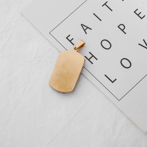 Detailed close-up of a classic 18k gold-plated dog tag pendant on a faith themed card