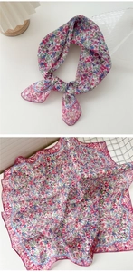 Detail of floral linen-cotton square scarf showing vibrant prints and wavy hem edges