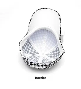 Detail view of the houndstooth baseball cap interior with white lining and stitching