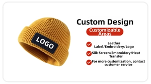 Detail of a bright mustard yellow knit beanie featuring a custom black logo woven patch